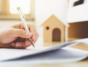 Person Writing Next To Birdhouse